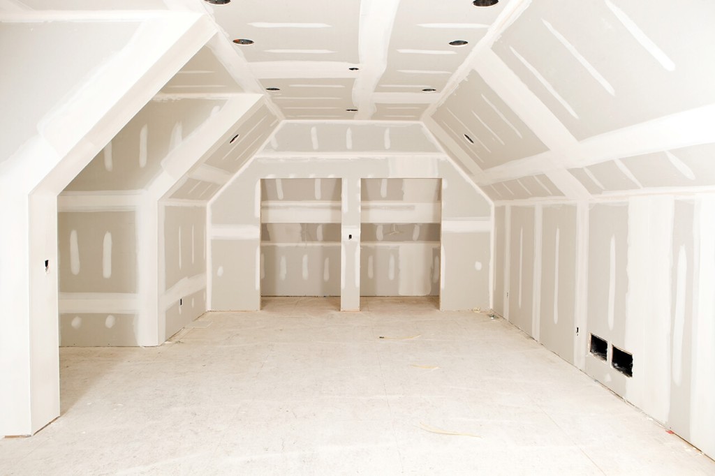 Drywall installation on a vaulted ceiling during a rural home remodel